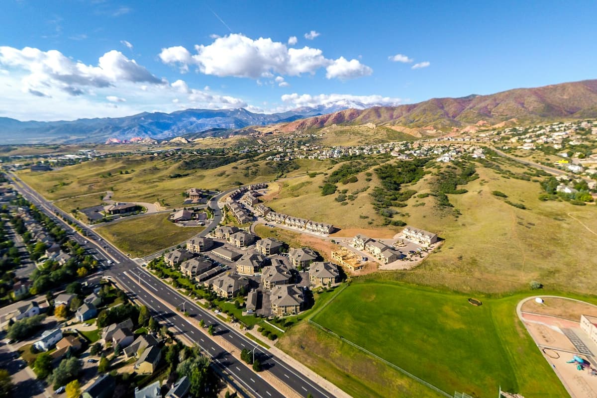 Aerial view of a Colorado Springs neighborhood with the Front Range behind it